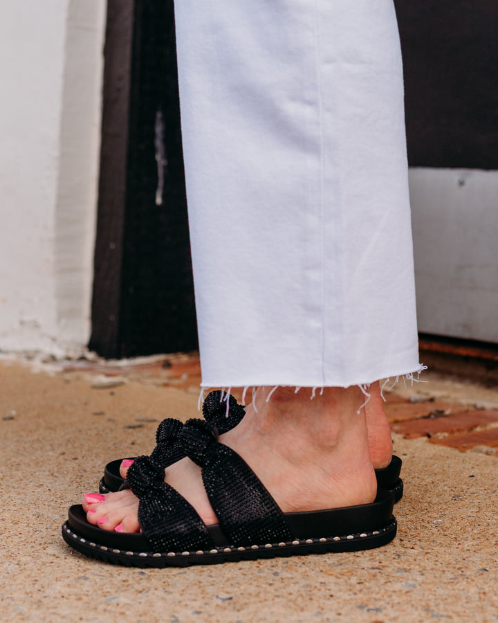 Jessica Simpson: Caralyna Flat Sandal in Black Shimmer - The Vogue Boutique