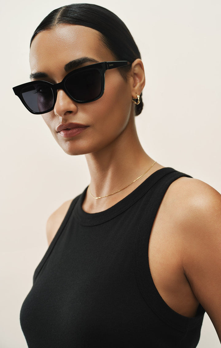 Woman wearing Z Supply High Tide Polished Black-Grey Polarized cat-eye sunglasses with black tank top