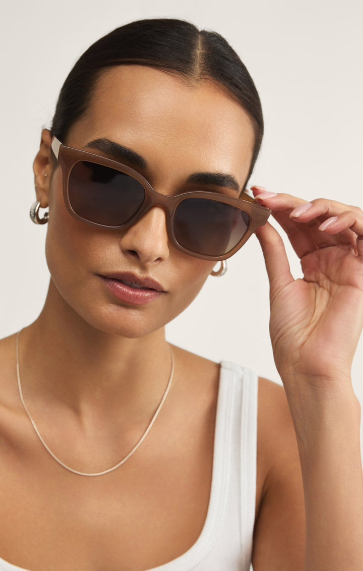 Woman wearing Z Supply High Tide Taupe gradient polarized sunglasses with brown frames
