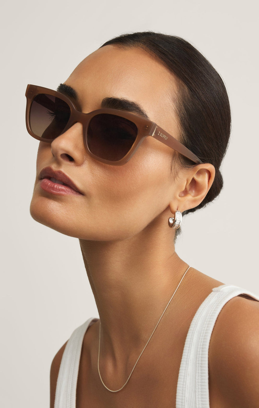 Woman wearing Z Supply High Tide Taupe gradient polarized sunglasses with brown frames
