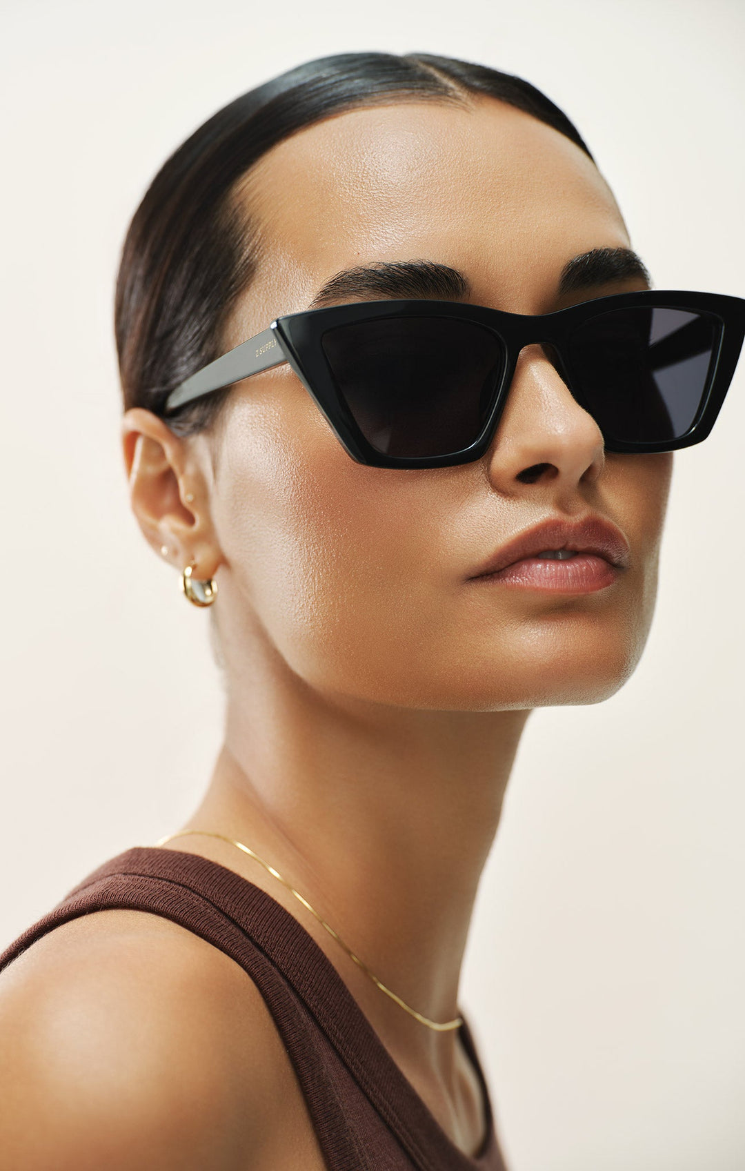 Woman wearing Z Supply Villa Polished Black cat-eye sunglasses with grey polarized lenses