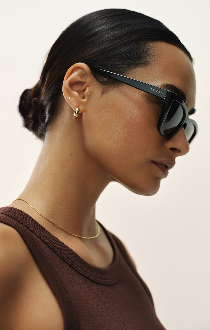 Woman wearing Z Supply Villa Polished Black-Grey Polarized sunglasses in profile view