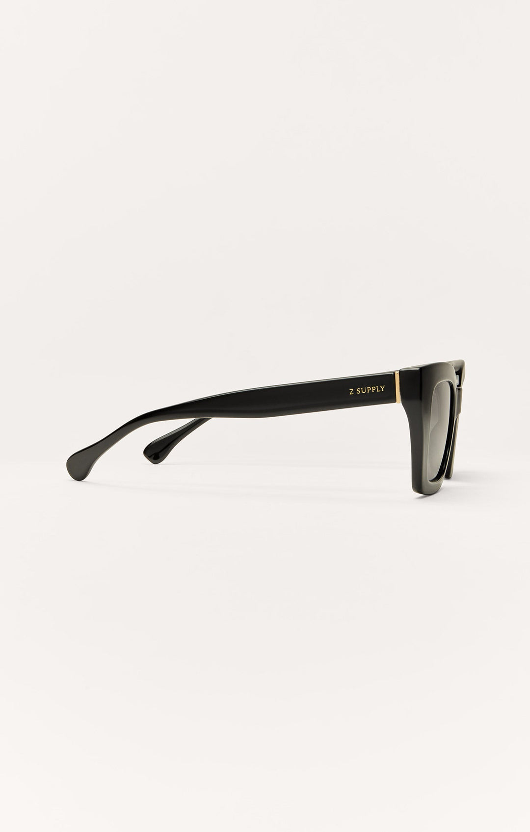 Z Supply Hideaway sunglasses in polished black with gold accent, side profile view