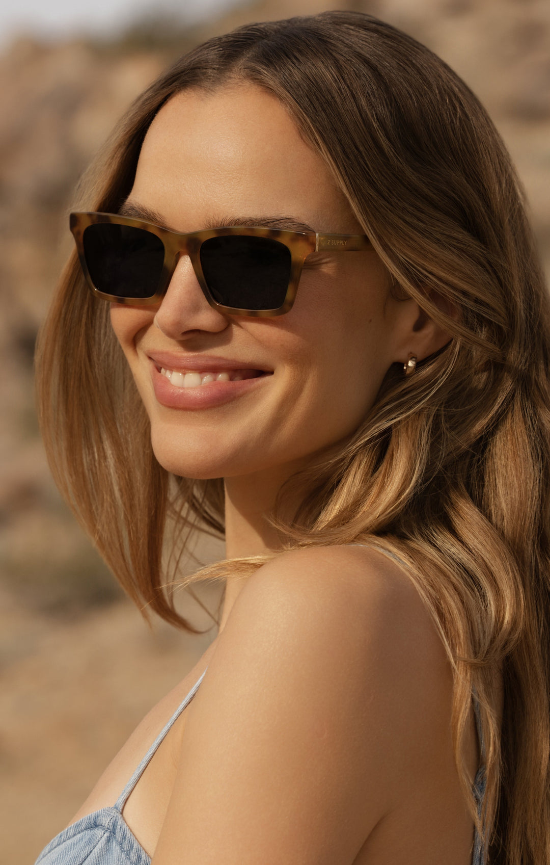 Woman wearing Z Supply Studio Brown Tortoise-Grey sunglasses outdoors in sunny desert setting