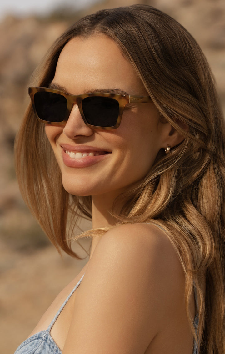Woman wearing Z Supply Studio Brown Tortoise-Grey sunglasses outdoors in sunny desert setting