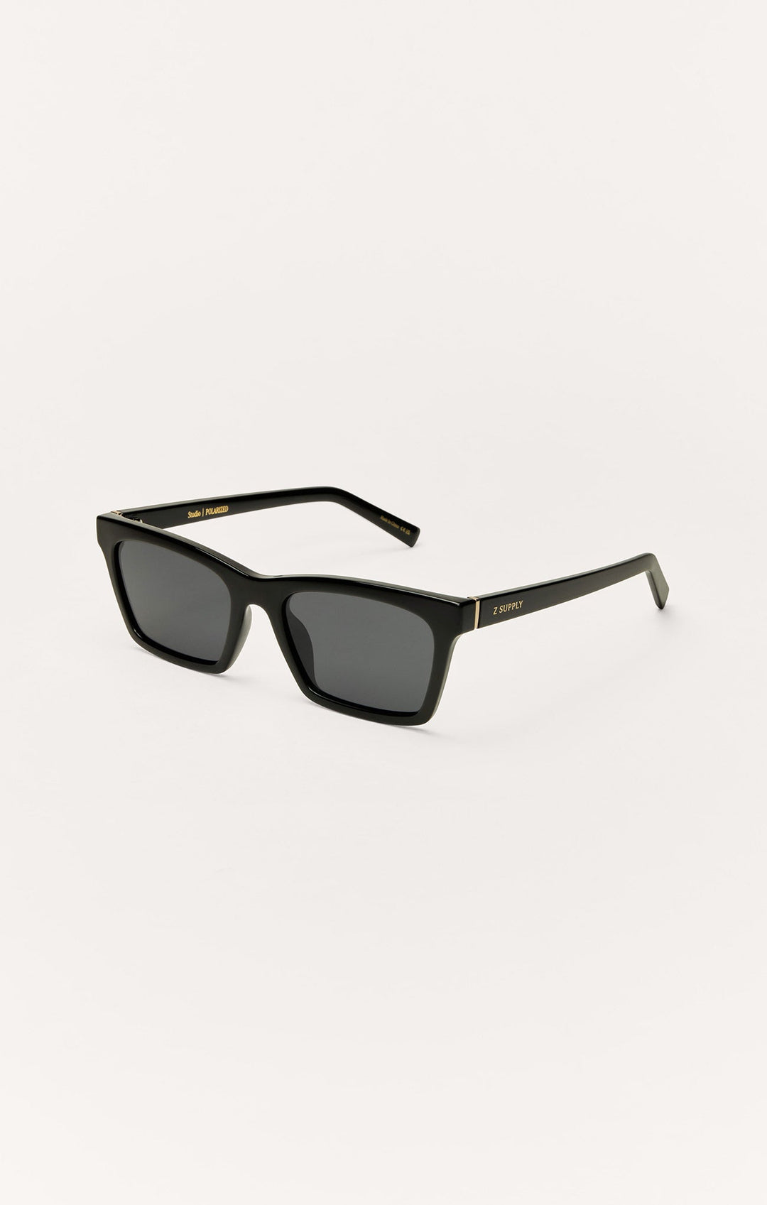 Z Supply Studio polarized sunglasses in polished black with dark grey lenses and gold accents