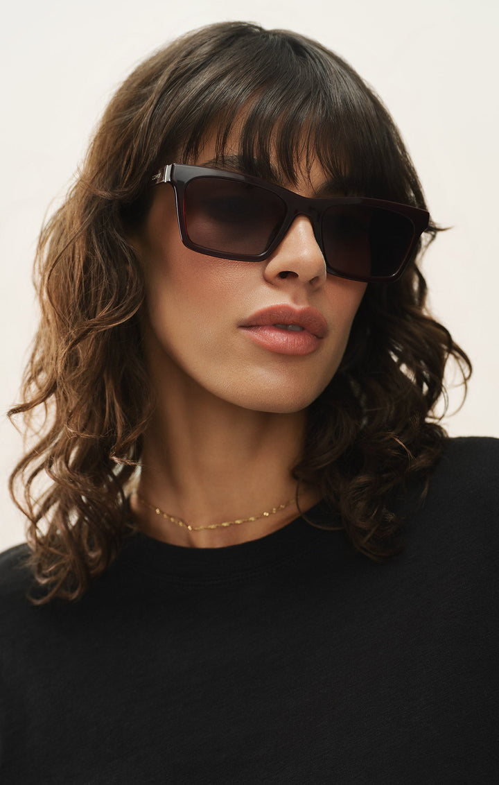 Woman wearing Z Supply Studio Brown Tortoise sunglasses with grey gradient lenses