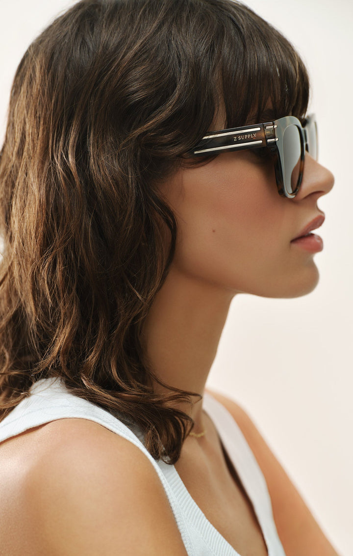 Woman wearing Z Supply Front Row Brown Tortoise sunglasses in profile view