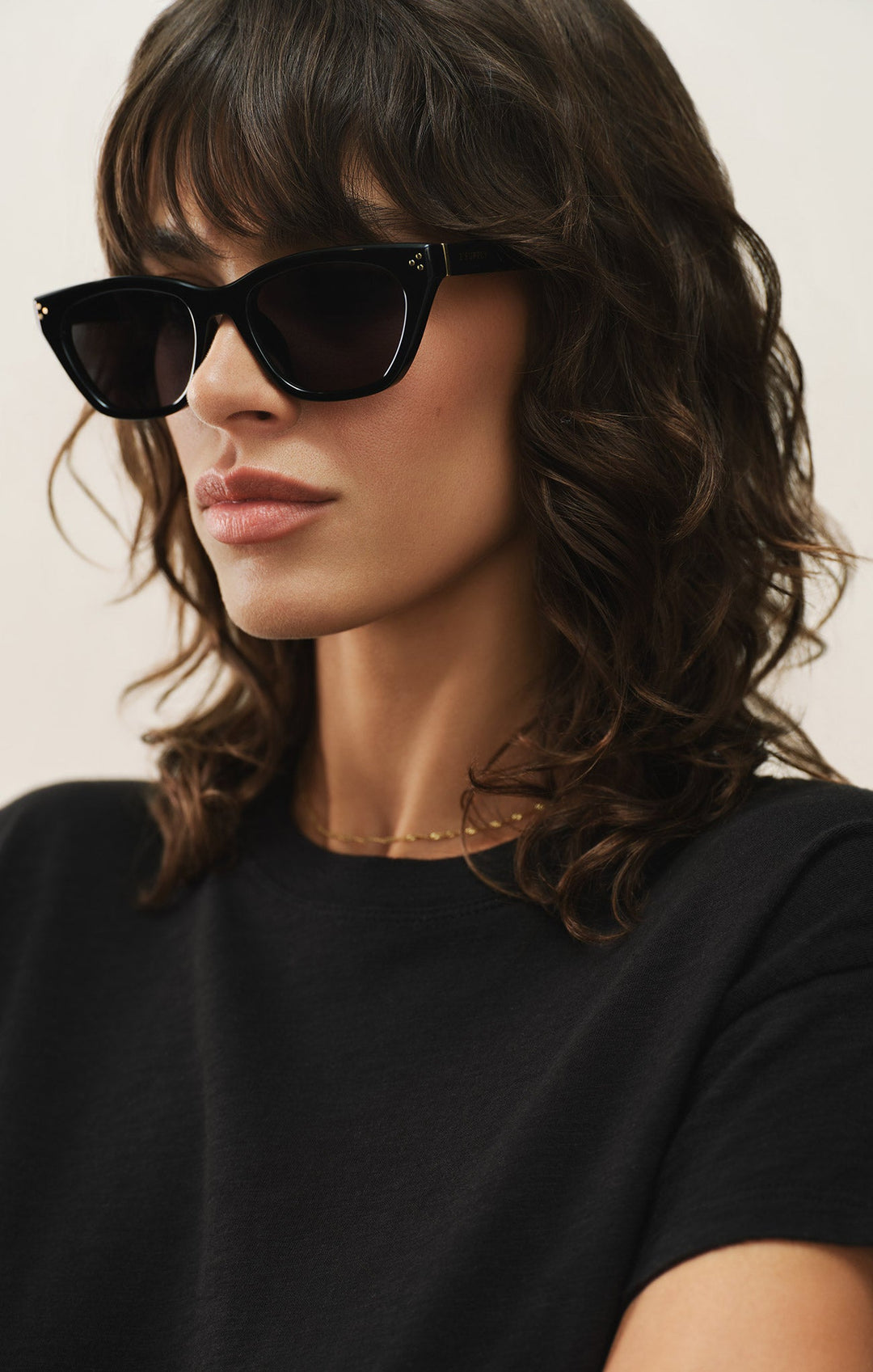 Woman wearing Z Supply Midnite polished black cat-eye sunglasses with grey polarized lenses