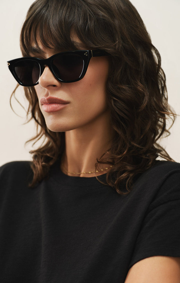 Woman wearing Z Supply Midnite polished black cat-eye sunglasses with grey polarized lenses