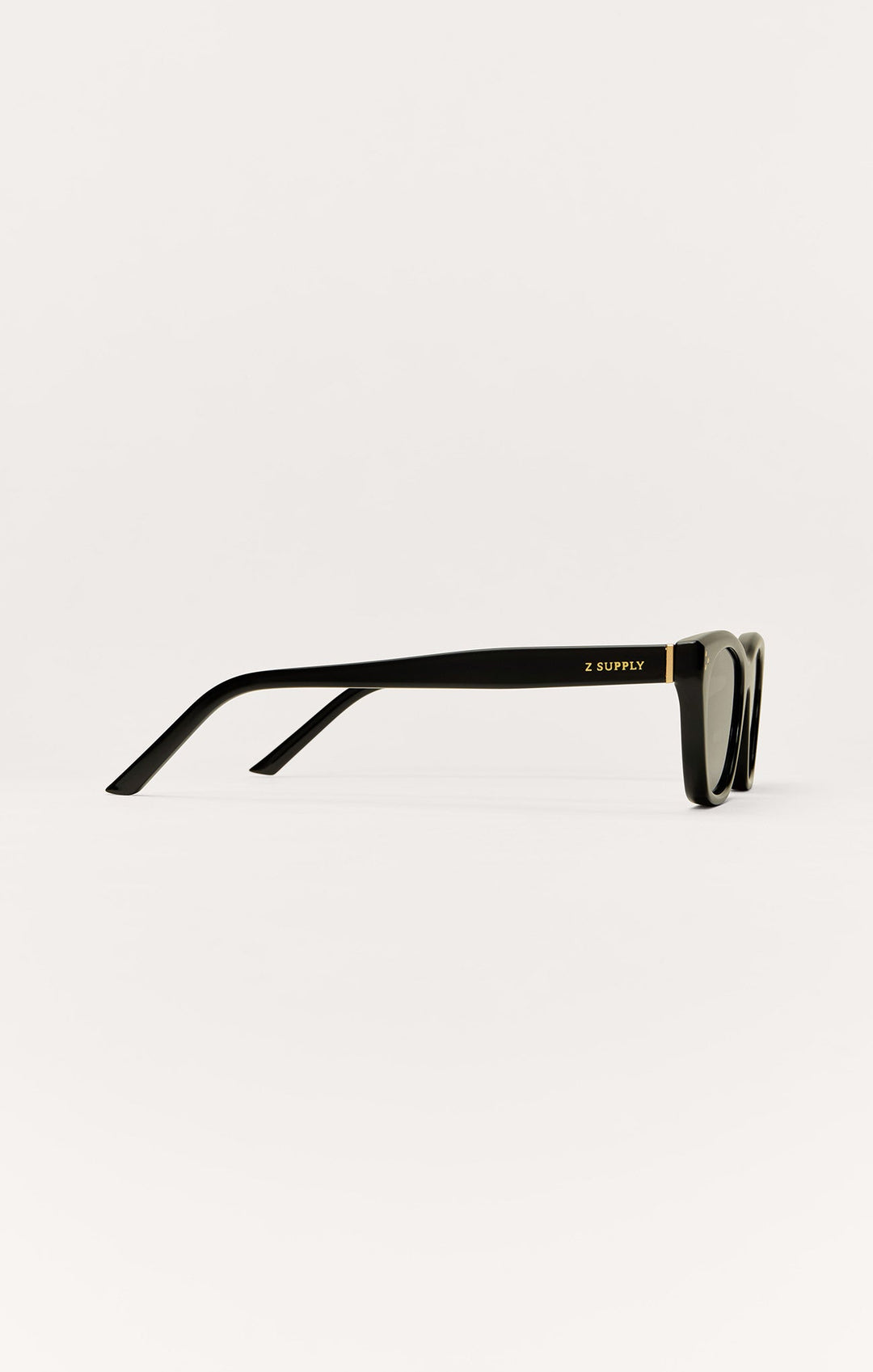 Z Supply Midnite sunglasses in polished black with gold accent, side profile view