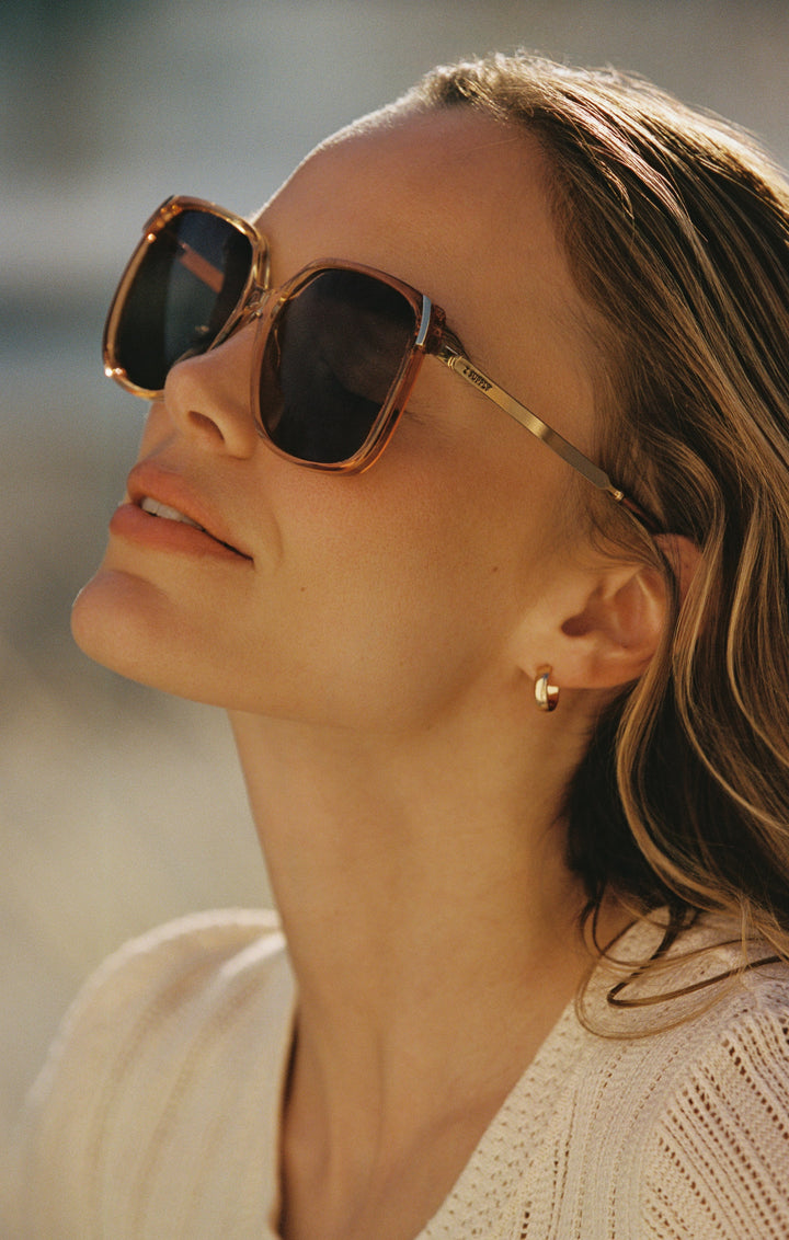 Woman wearing Z Supply Riviera Brown Tortoise oversized sunglasses with gradient lenses outdoors