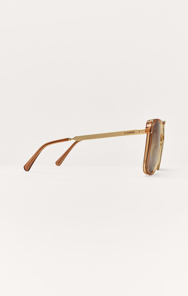 Z Supply Riviera sunglasses side view showing gold metal arms and brown transparent frames