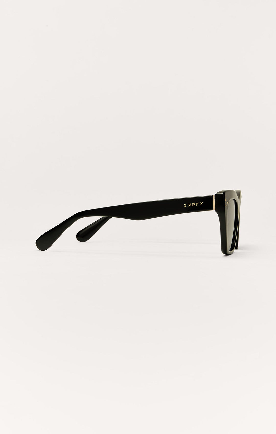 Z Supply Park Ave sunglasses in polished black with gold hardware, side profile view