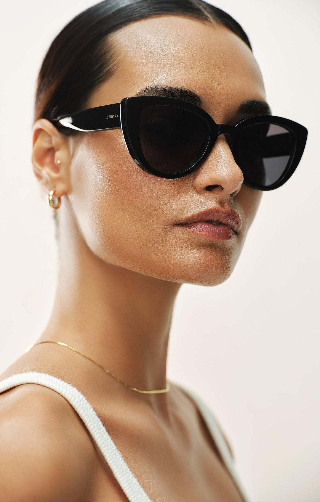 Model wearing Z Supply Golden Hour cat-eye sunglasses in polished black with grey polarized lenses
