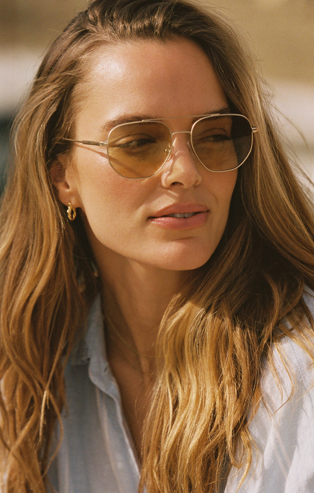 Woman wearing Z Supply Highway Tort Gold gradient polarized sunglasses outdoors in sunlight
