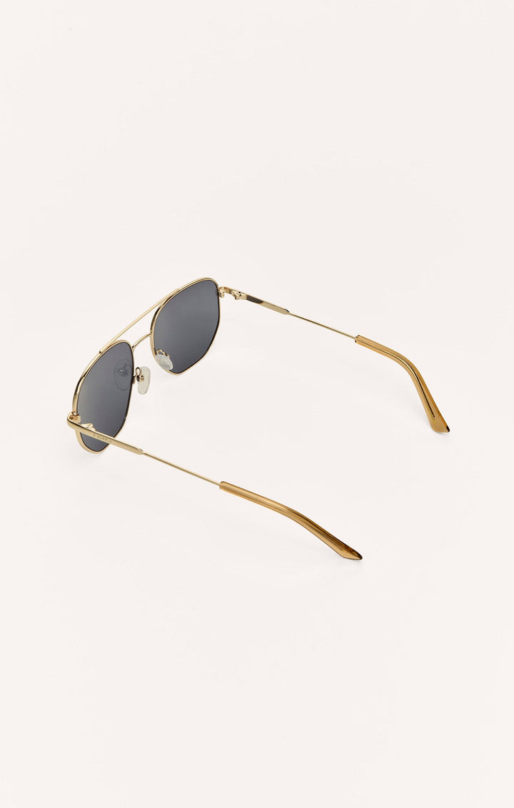 Z Supply Highway sunglasses with gold metal frame and dark grey polarized lenses, angled view