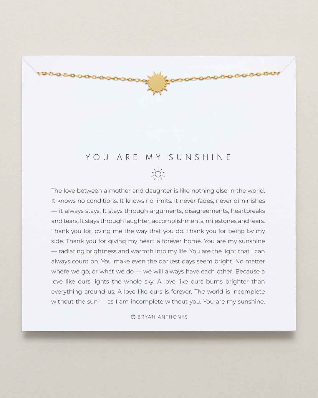Bryan Anthony You Are My Sunshine gold necklace with sun pendant on card