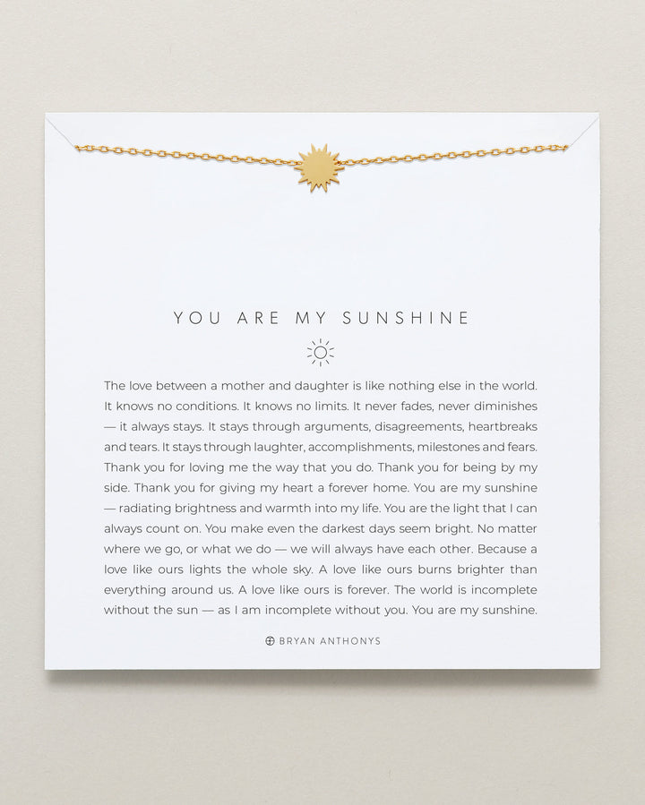 Bryan Anthony You Are My Sunshine gold necklace with sun pendant on card