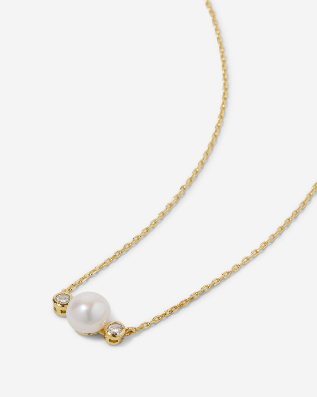 14k gold necklace with white pearl and two small diamonds on delicate chain