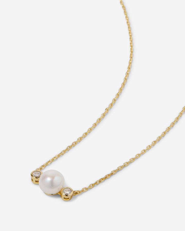 14k gold necklace with white pearl and two small diamonds on delicate chain
