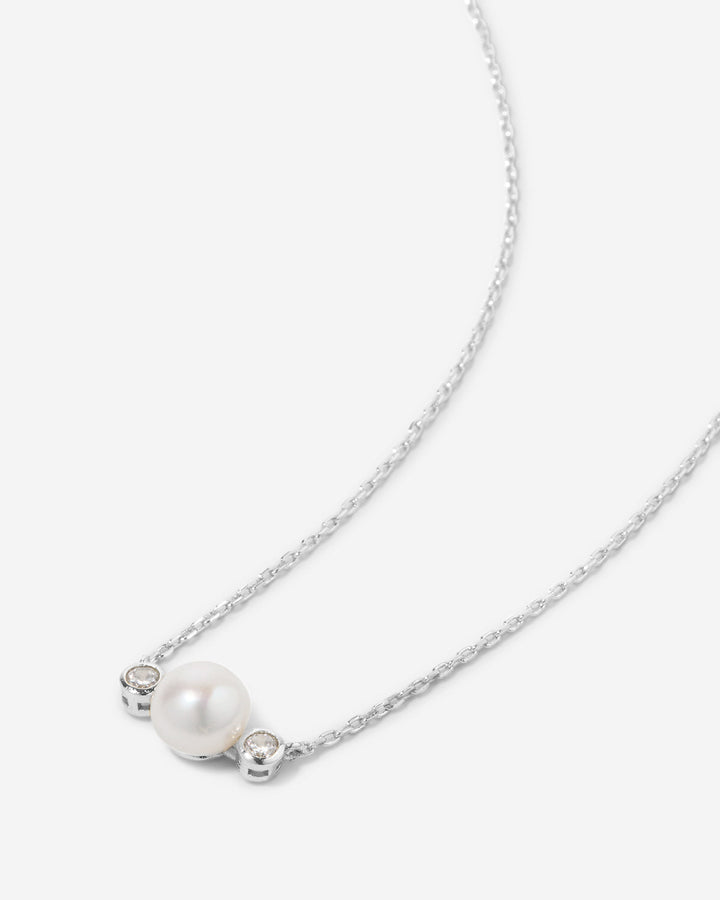 Delicate necklace with white pearl and crystal accents on silver chain