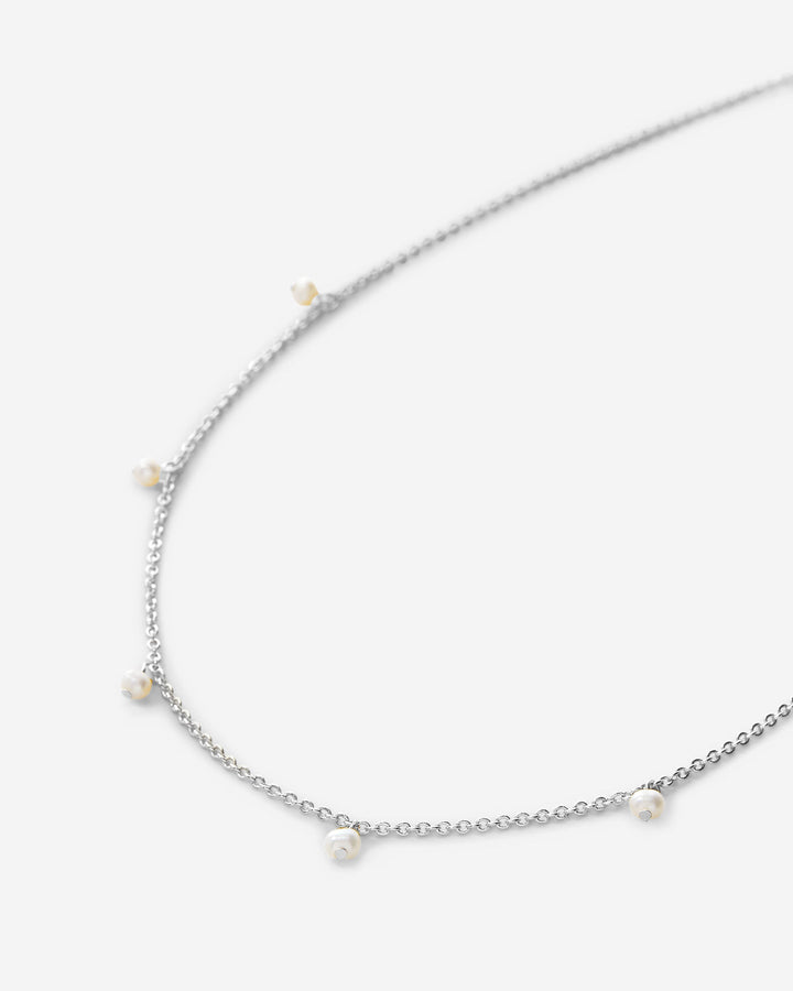 Silver chain choker necklace with small pearl-like dangles on clean background