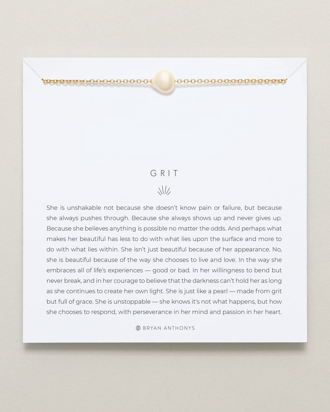 Bryan Anthonys Grit necklace with gold chain and white pearl on inspirational card