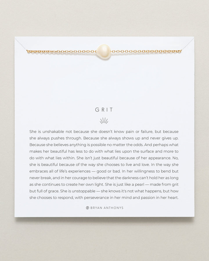 Bryan Anthonys Grit necklace with gold chain and white pearl on inspirational card