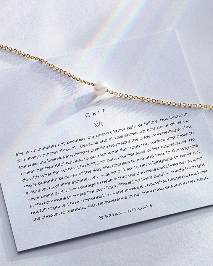 Bryan Anthonys Grit necklace in 14k gold with pearl pendant and inspirational card