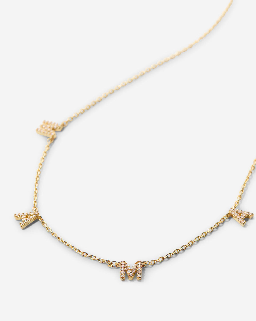 Gold chain necklace with crystal-encrusted letter charms spelling MAMA
