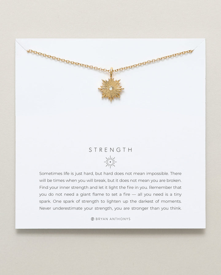 Bryan Anthonys Strength necklace with gold starburst pendant and inspirational card