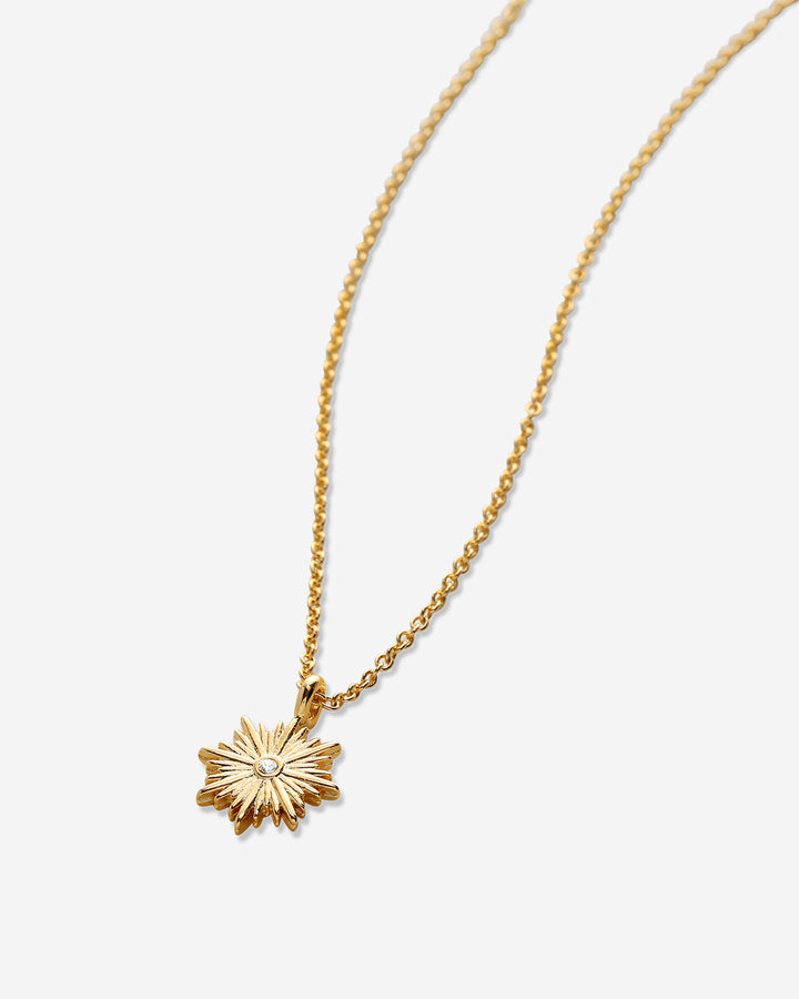 Bryan Anthony Strength Necklace featuring gold sunburst pendant with center crystal on chain