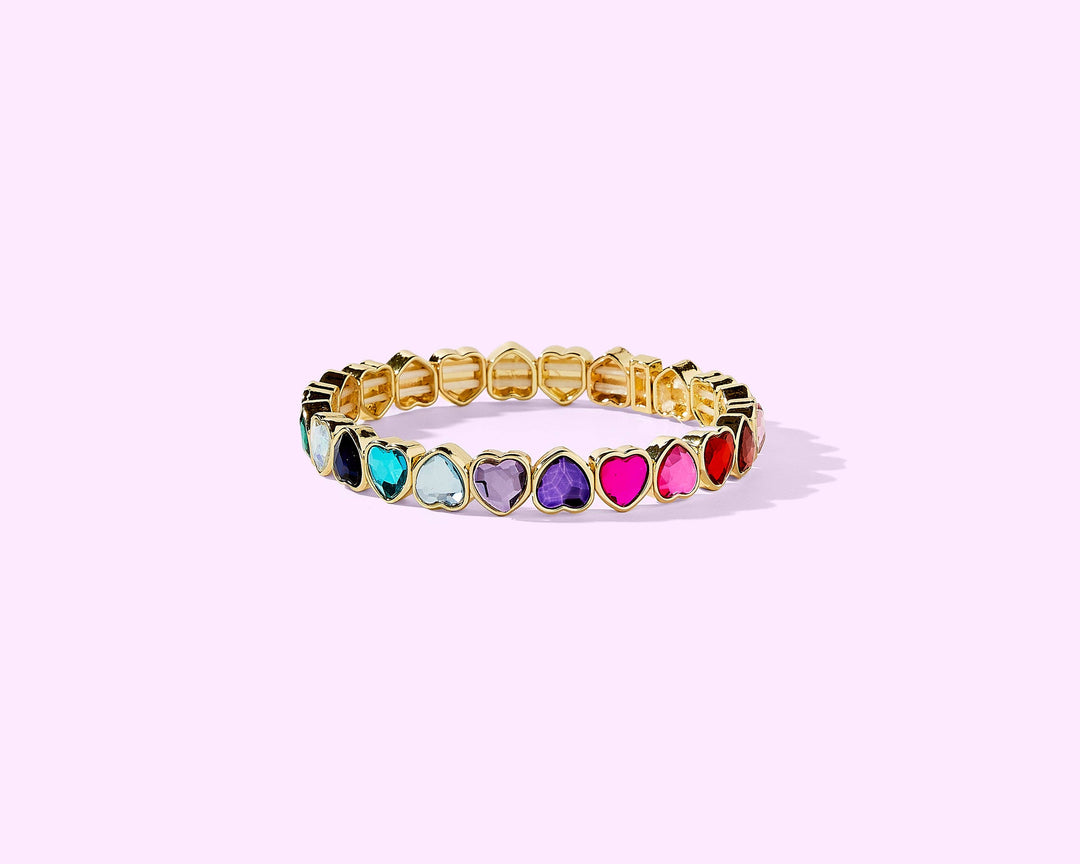 Gold stretch bracelet with colorful heart-shaped gemstones in rainbow pattern