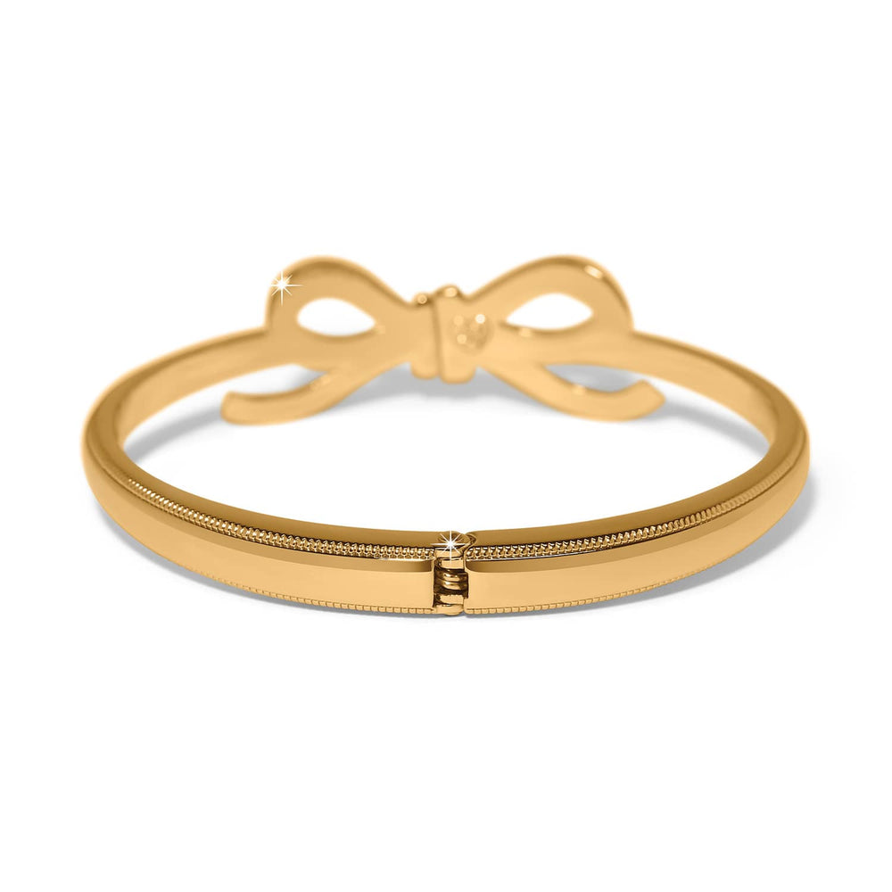 Brighton Illumina Bow Gold Hinged Bangle with decorative bow detail on white background