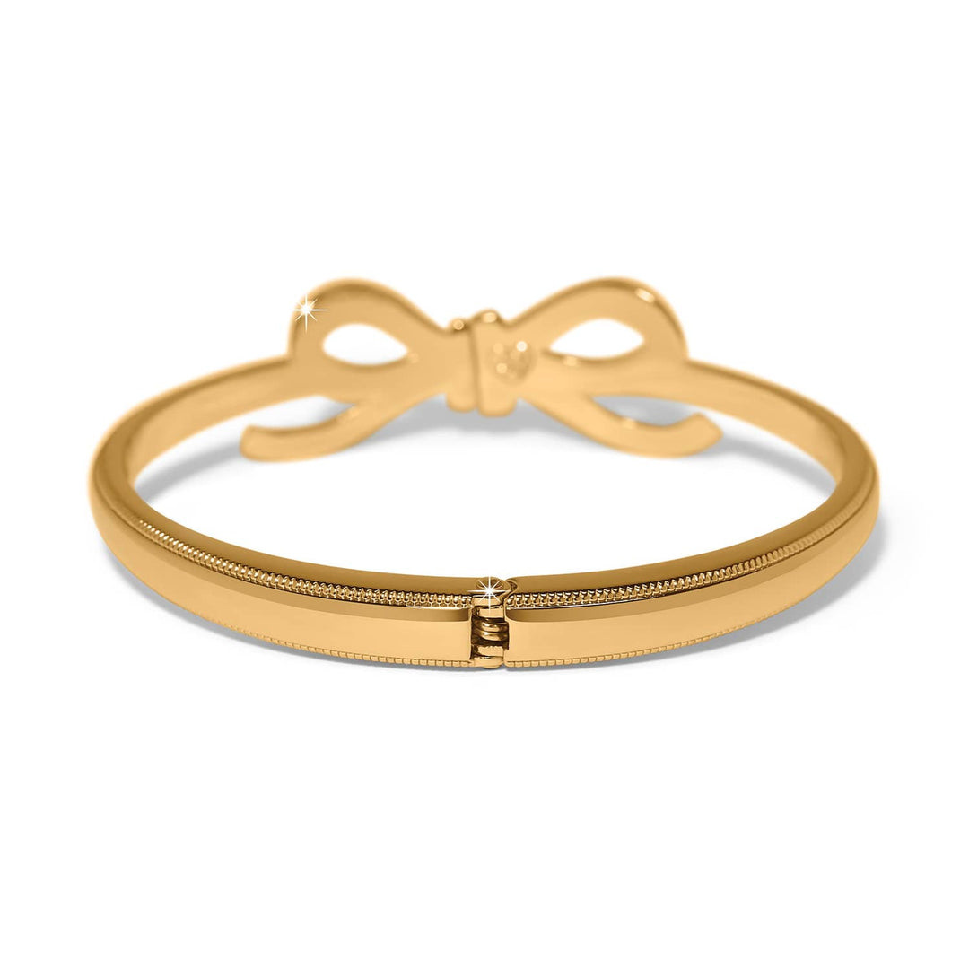 Brighton Illumina Bow Gold Hinged Bangle with decorative bow detail on white background
