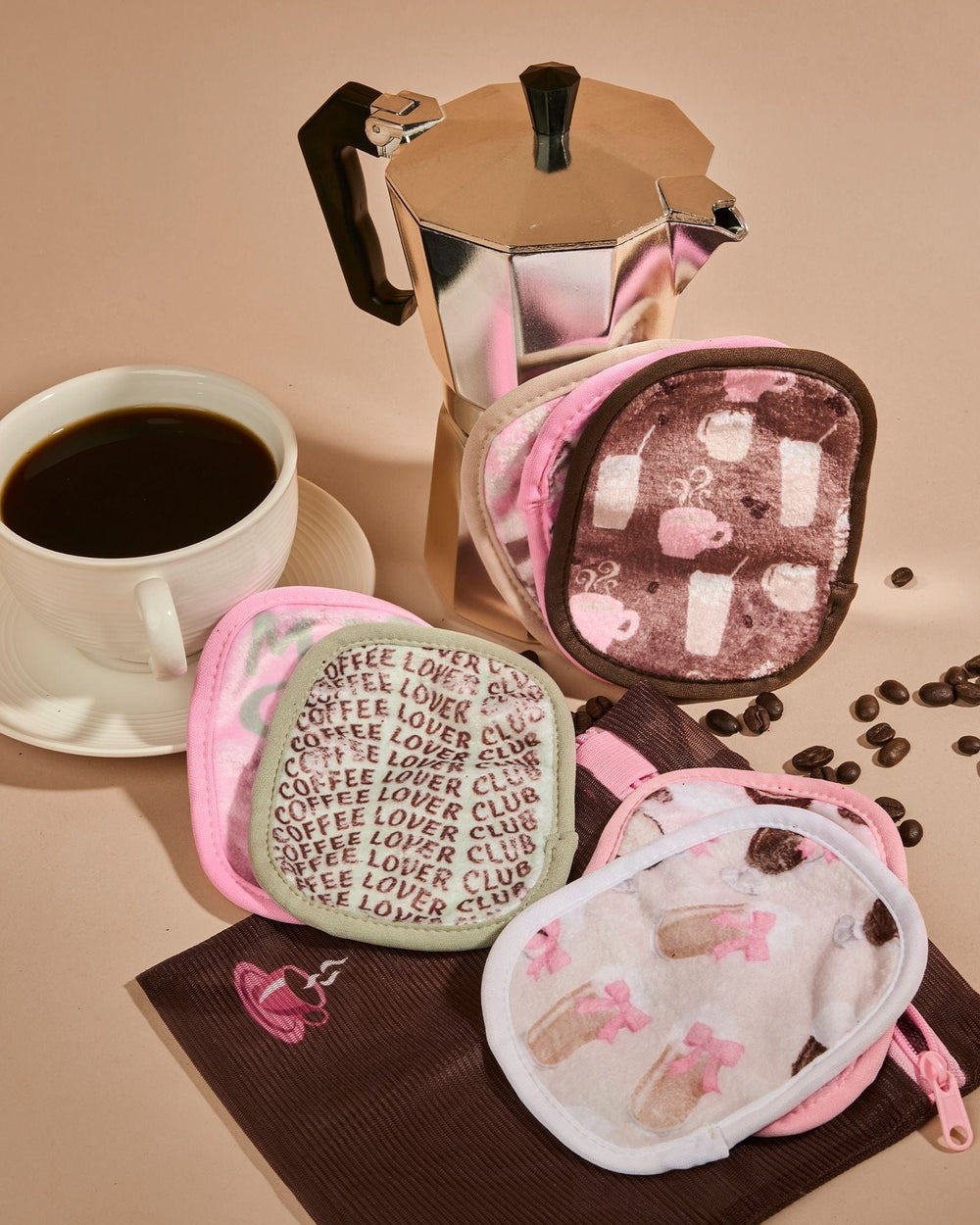 Coffee Break 7-Day makeup eraser set with pink pouches featuring coffee-themed patterns
