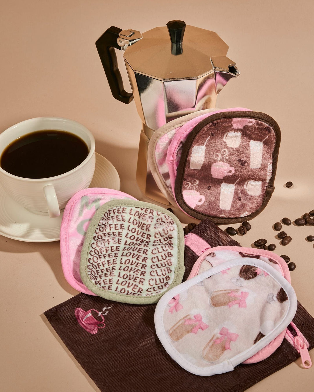 Coffee Break 7-Day makeup eraser set with pink pouches featuring coffee-themed patterns