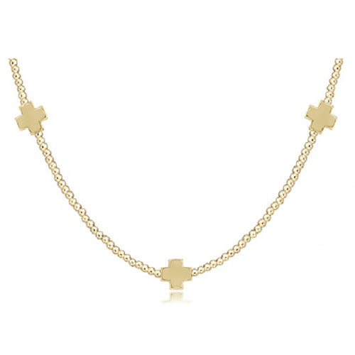 Enewton gold chain necklace with three cross charms on clean white background